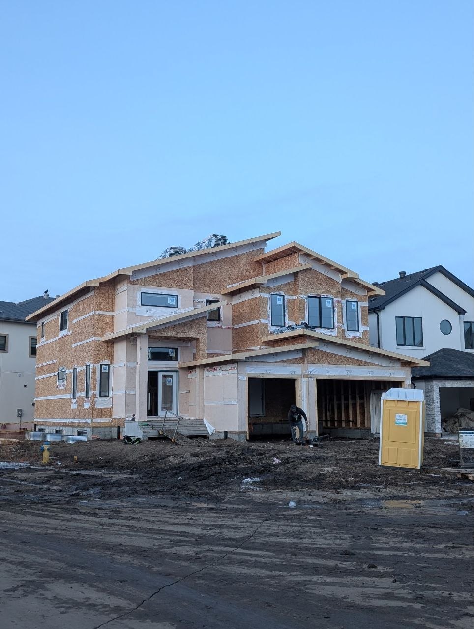 Two-storey house framed and wrapped with an attached garage package